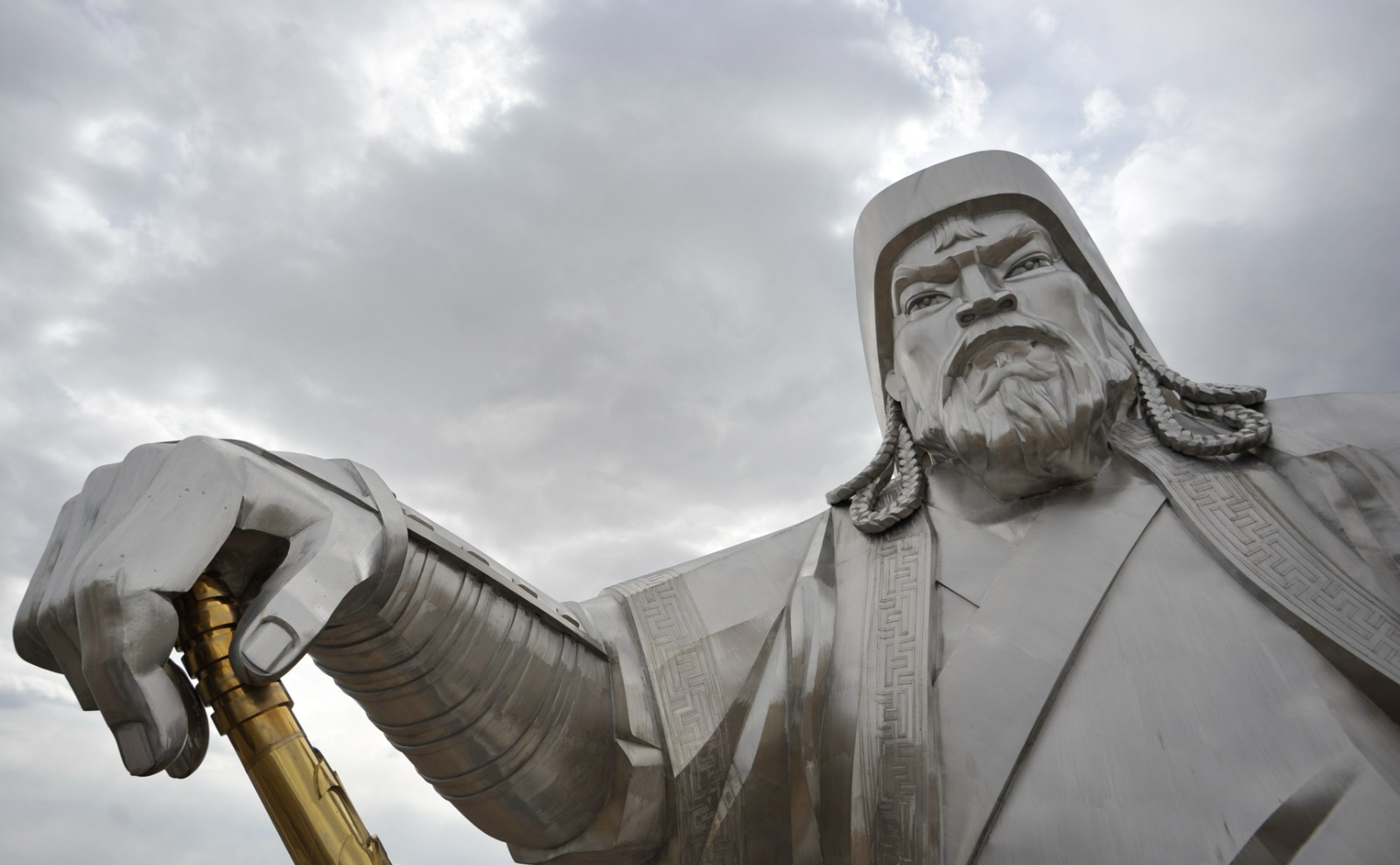 close up of silver statue of genghis khan looking fierce