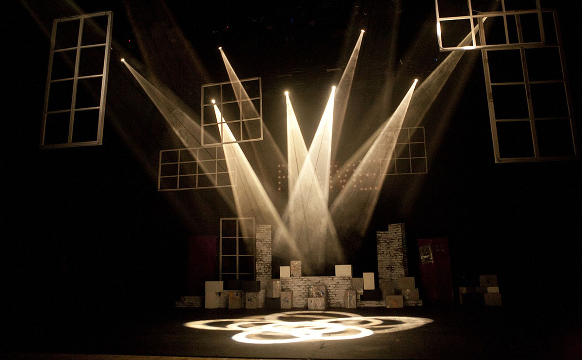 blank black stage lit with white spotlights