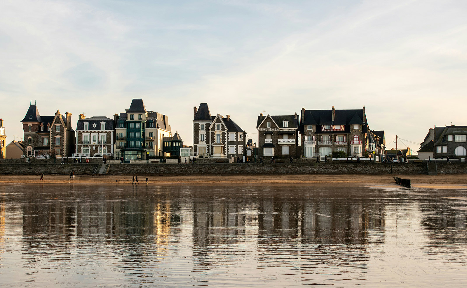 brown multi-story houses sitting in the edge of the ocean