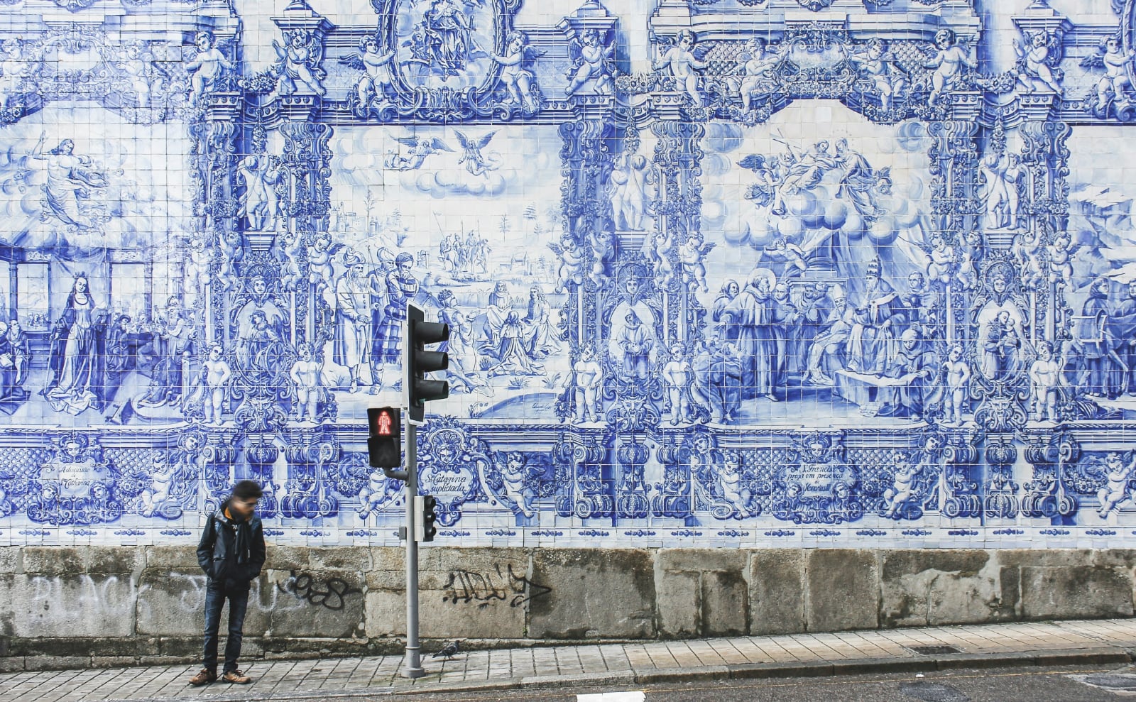 blue and white tile mural on the street in porto portugal