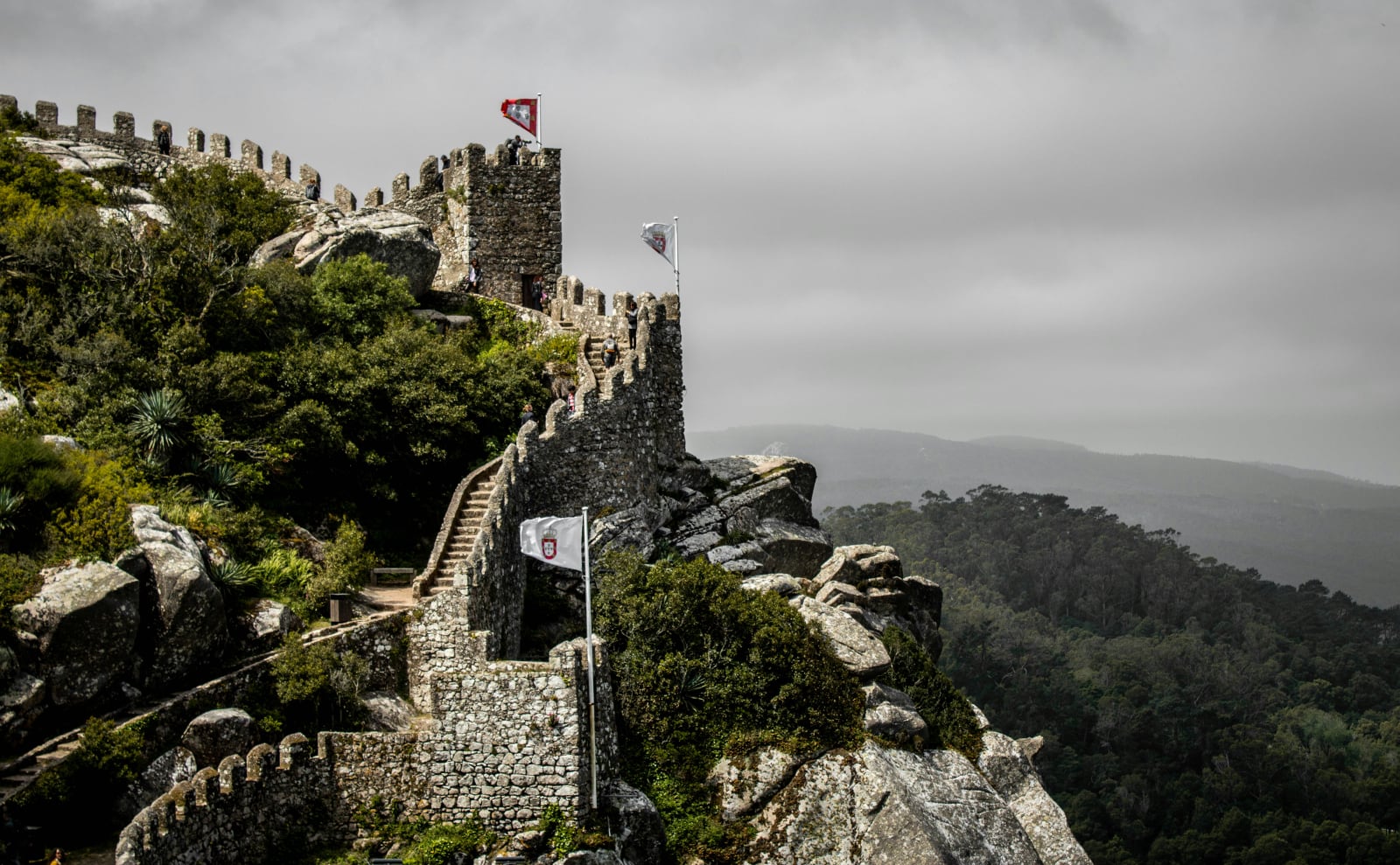 gothic gray stone buildings and walls that look like they're tumbling down a mountainside