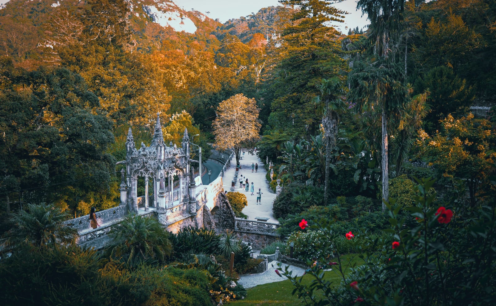 a neo-gothic folly made of gray stone tucked into a leafy green garden