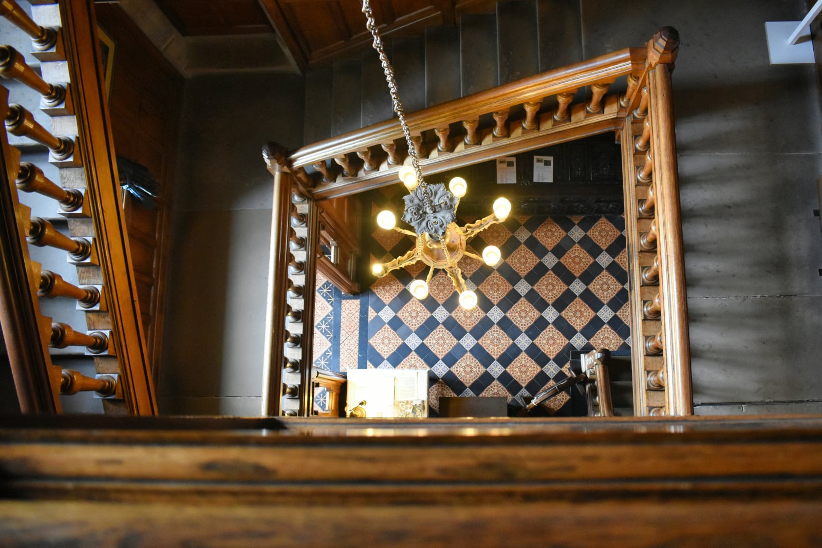 chandelier hanging over a twisting staircase