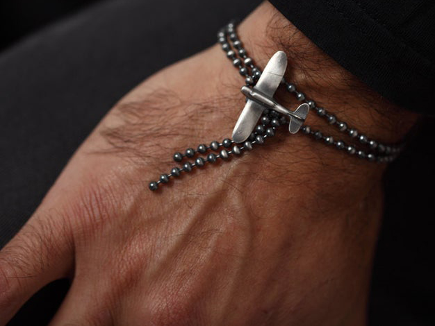 silver bead chain bracelet with airplane-shaped clasp
