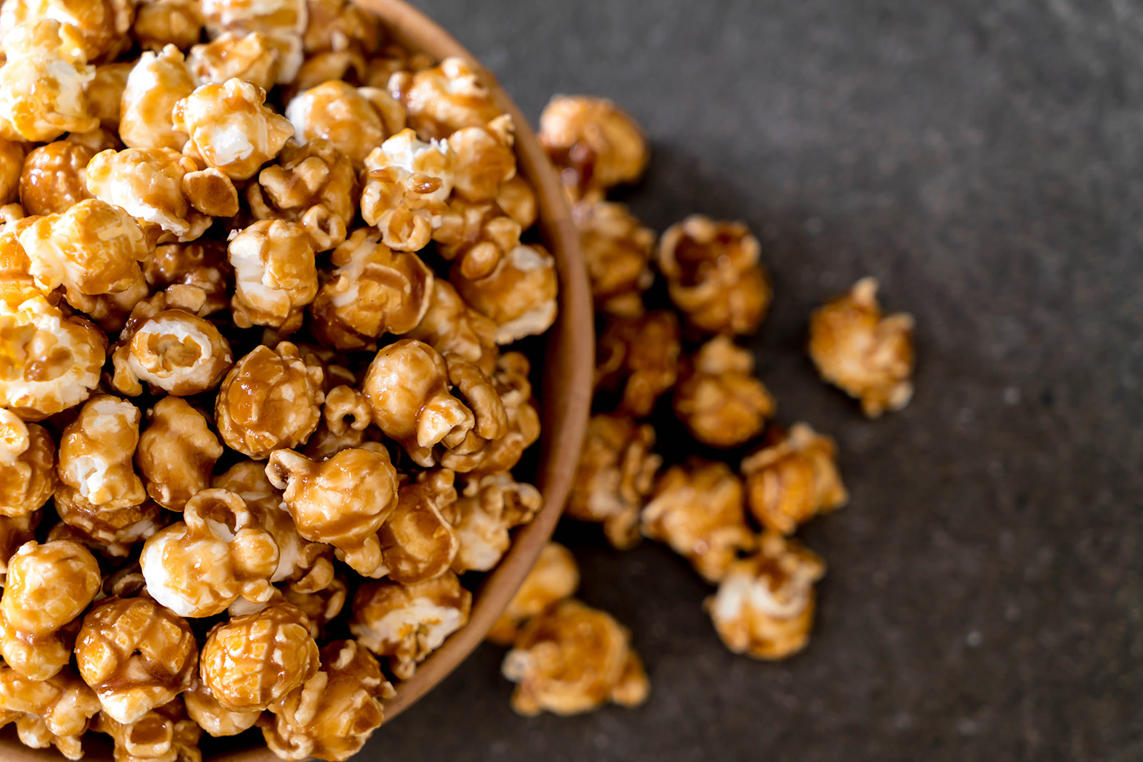 caramel popcorn in a wooden bowl