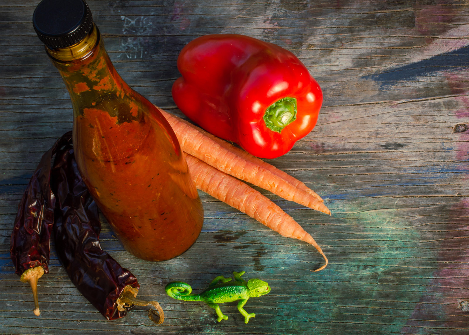  bottle of red salsa on wooden table