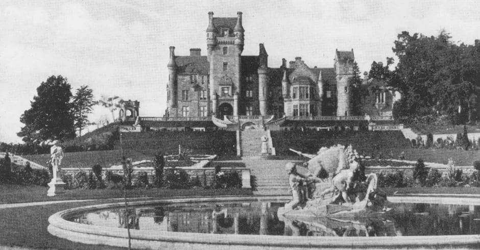 black and white photo of crenulated castle with turrets
