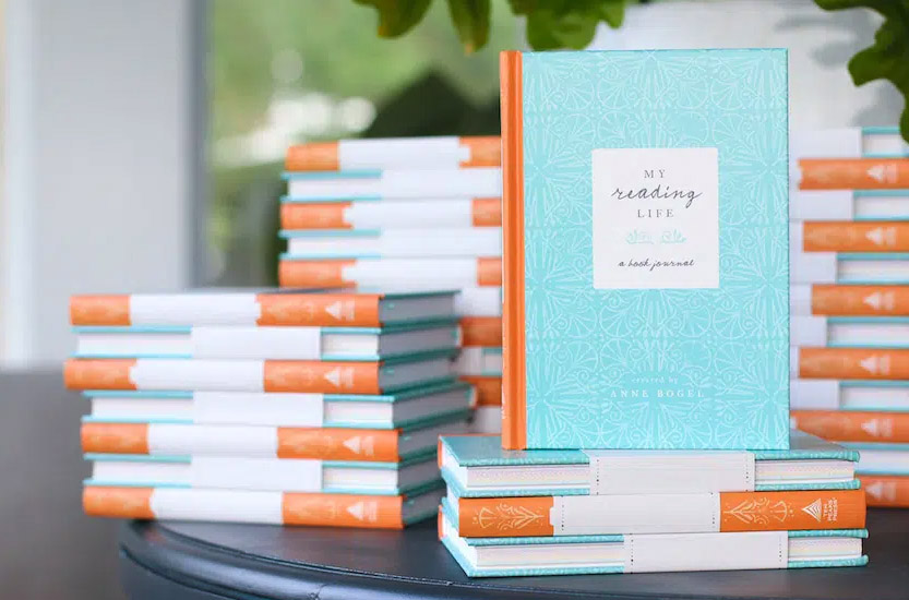 stacks of the torquoise and coral colored journal
