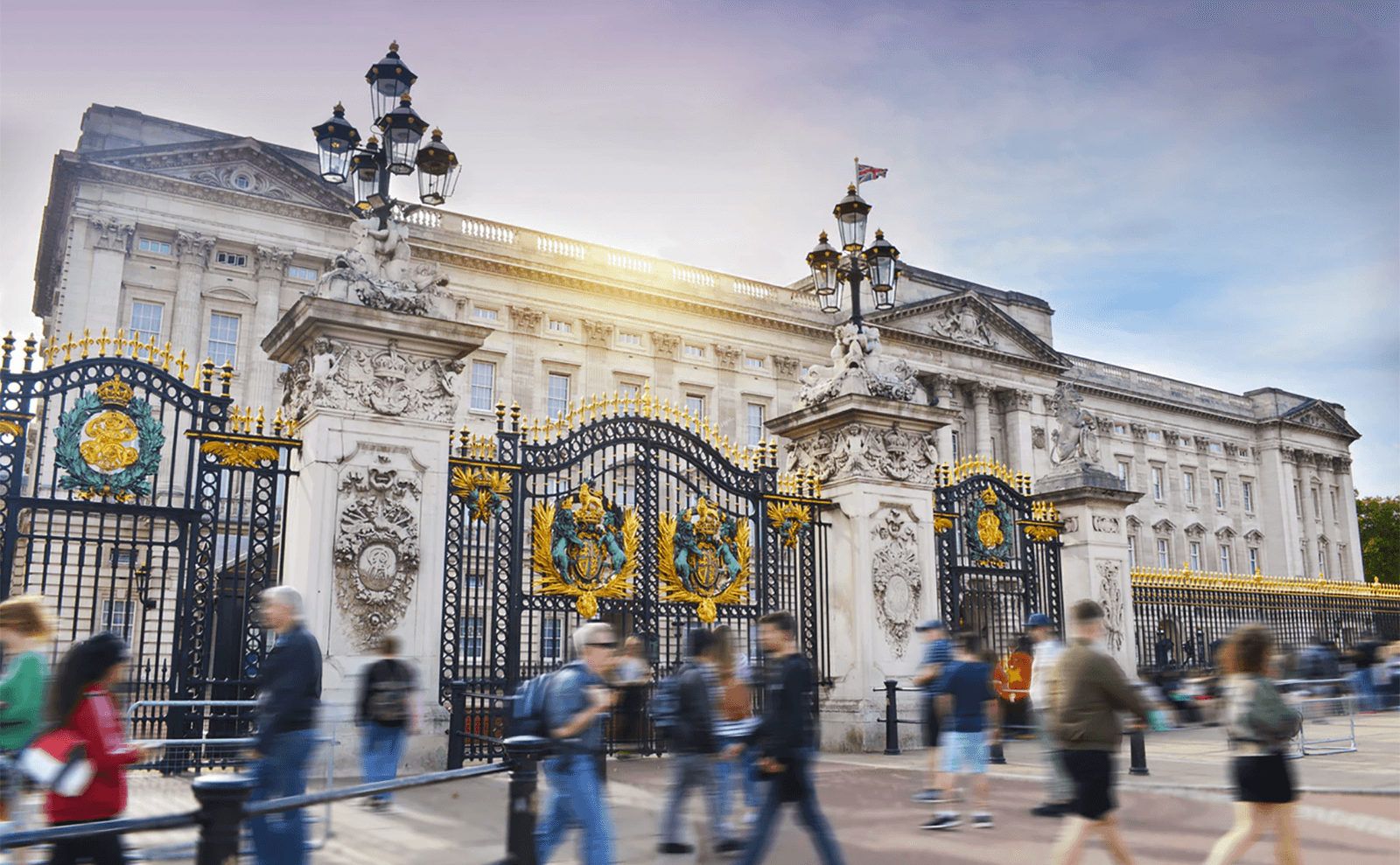 people walking in front of Buckingham Palace