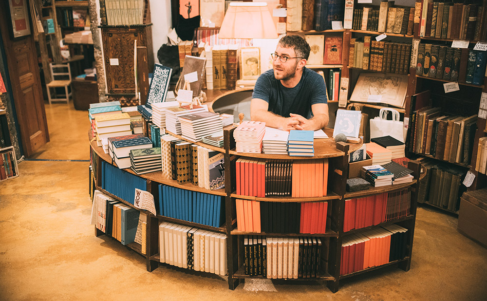 a curved desk lined with books