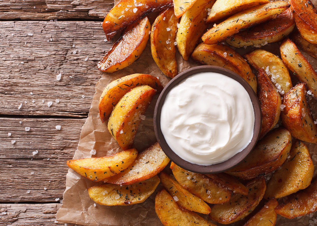 potato wedges sprinkled with salt on a wooden table