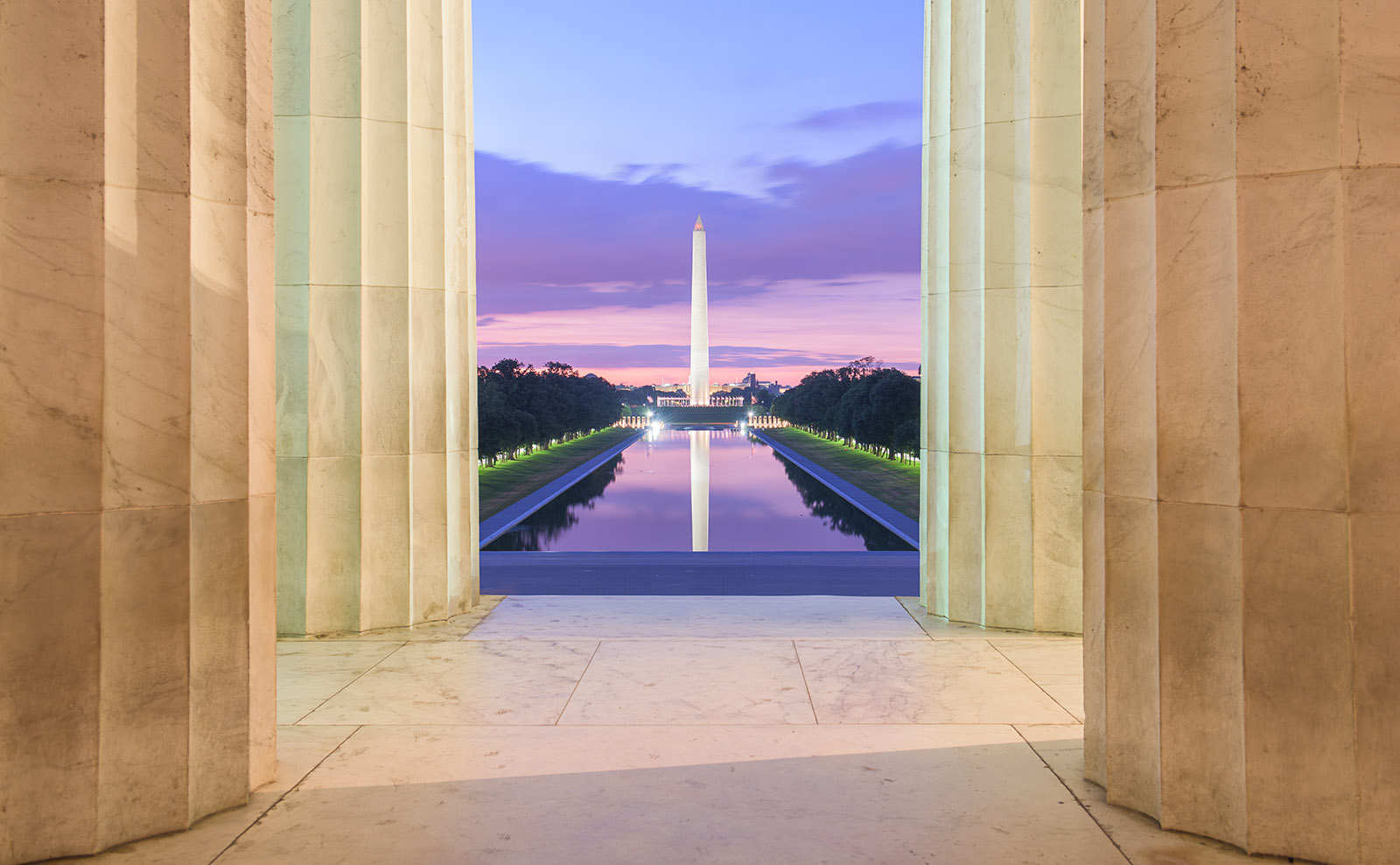 washington monument and reflecting pool at twilight in washington, dc