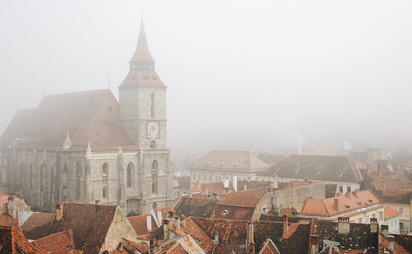 buildings in the fog in brașov, romania