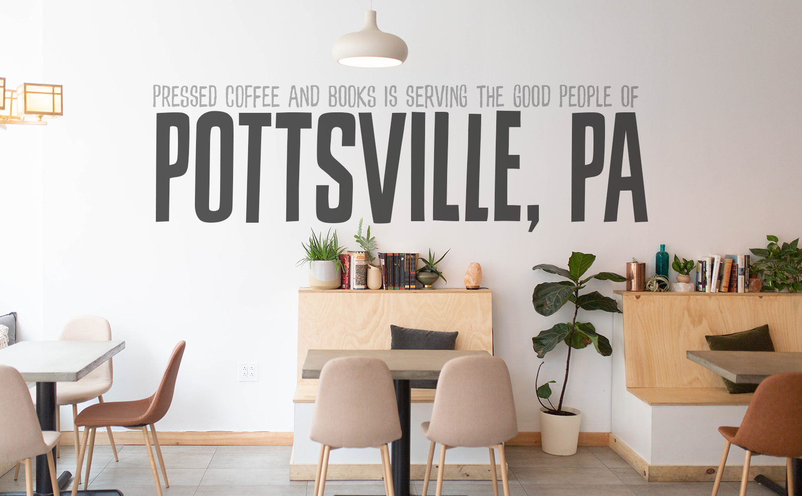 interior of pressed coffee and books with wooden tables and chairs
