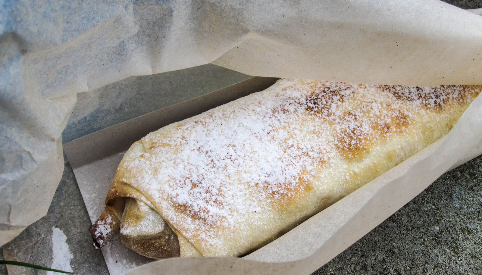 large apple strudel sprinkled with powdered sugar