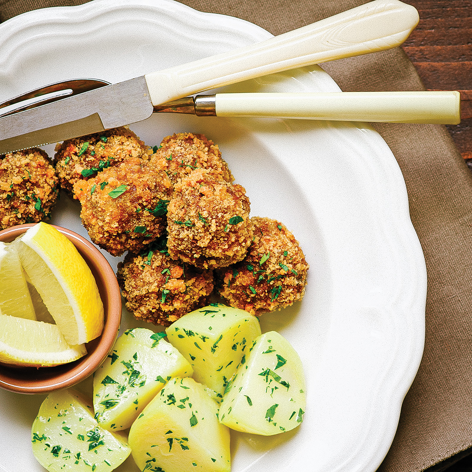 schnitzel meatballs and buttered potatoes on a plate