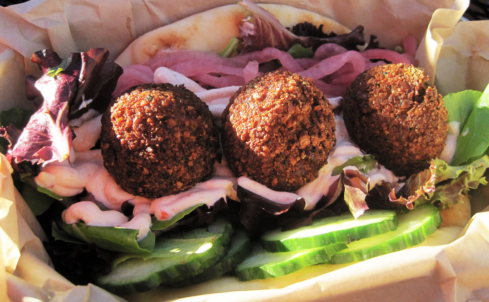 cups of red pomegranate seeds with spoons