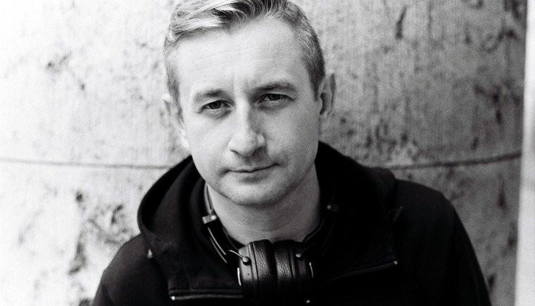  black and white photo of poet serhiy zhadan standing in front of a concrete wall